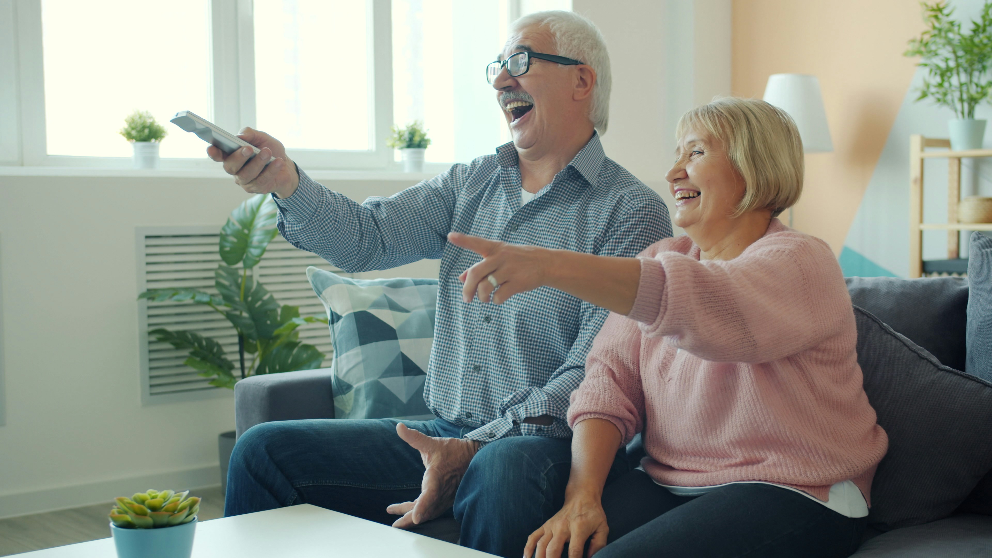 Elderly couple laughing and enjoying a joyful moment at home
